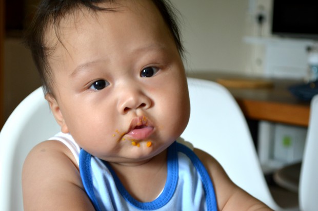 pensive baby eating